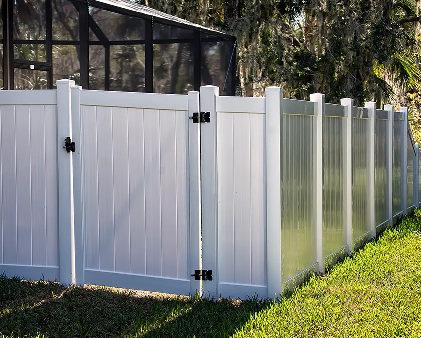 white vinyl fence trees greenish lawn